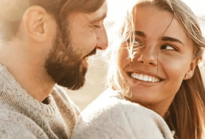 Husband and wife smiling and looking at each other, representing marc a. Minch, dmd