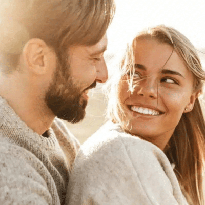 Husband and wife smiling and looking at each other, representing marc a. Minch, dmd