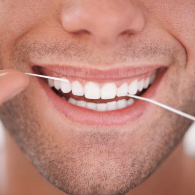 Closeup of man flossing, representing oral health and disease prevention