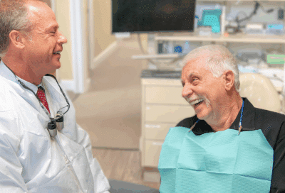 Dr. Marc a minch consulting with elderly patient, representing dental care for older adults
