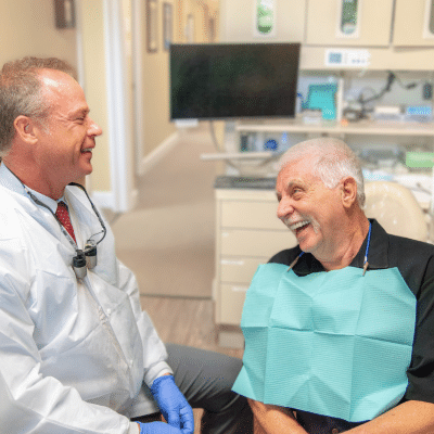 Dr. Marc a minch consulting with elderly patient, representing dental care for older adults