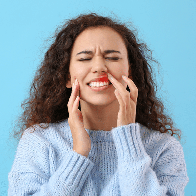 Woman experiencing dental discomfort, representing gum disease prevention